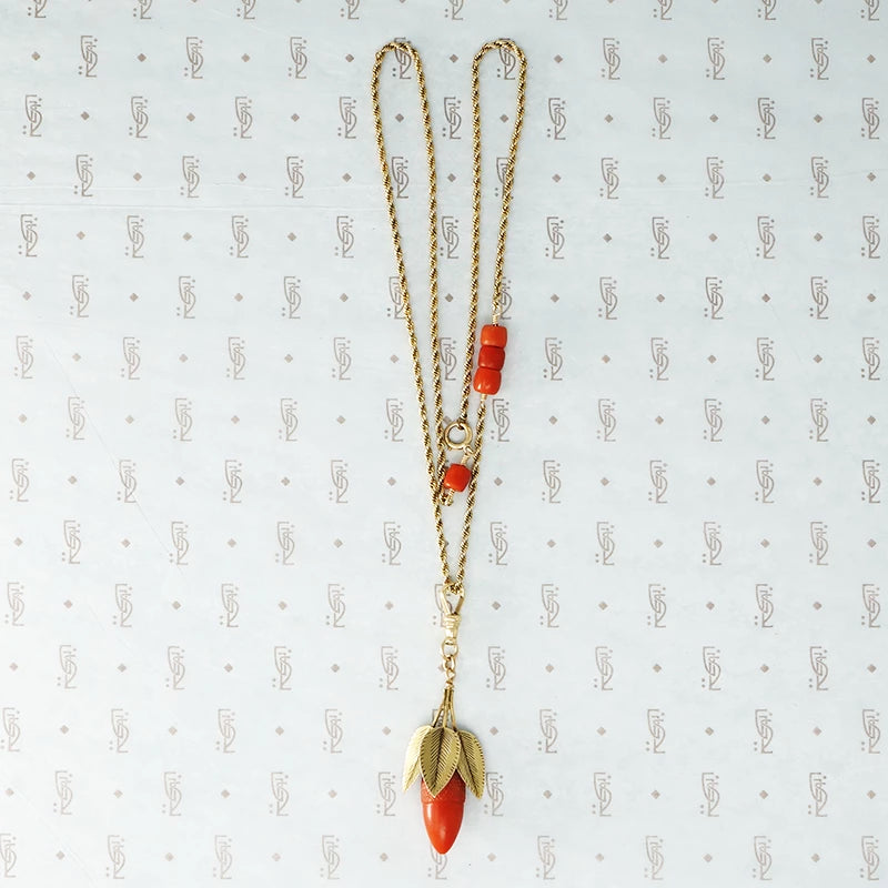 coral and gold acorn on a gold chain