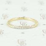 The diamond wheat band by 720 in yellow gold.