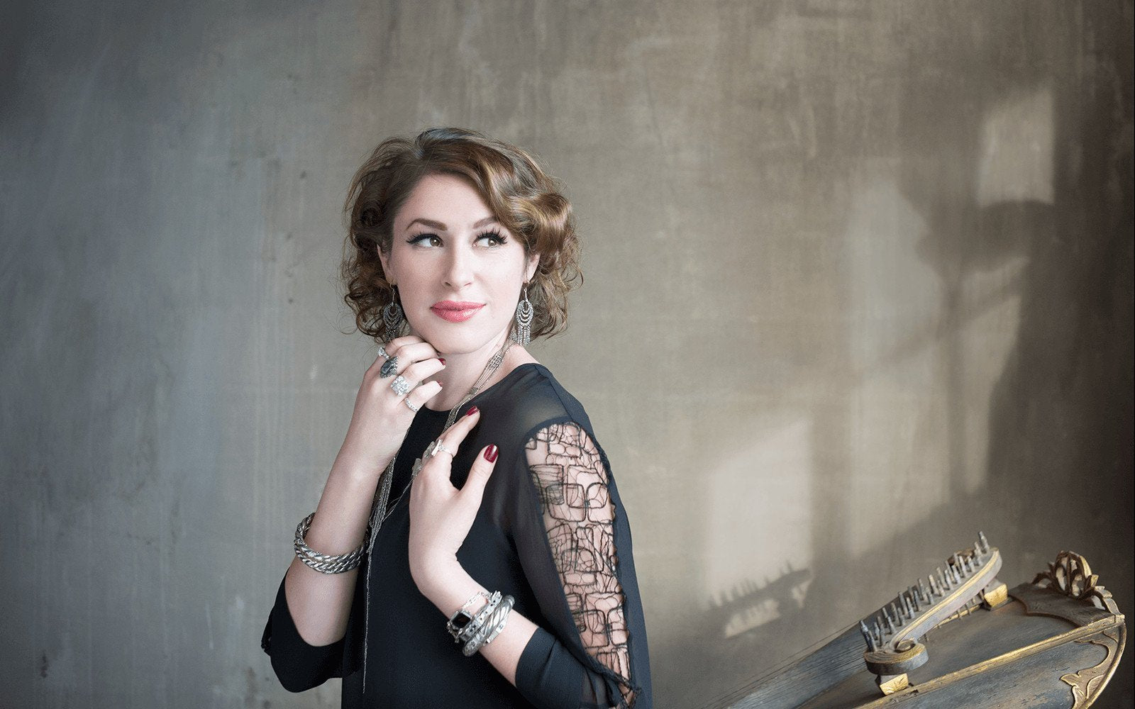 woman in a black lace dress wearing antique cut steel earrings