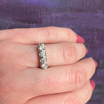 Four Sparkling Diamonds in Curvy White Gold Band