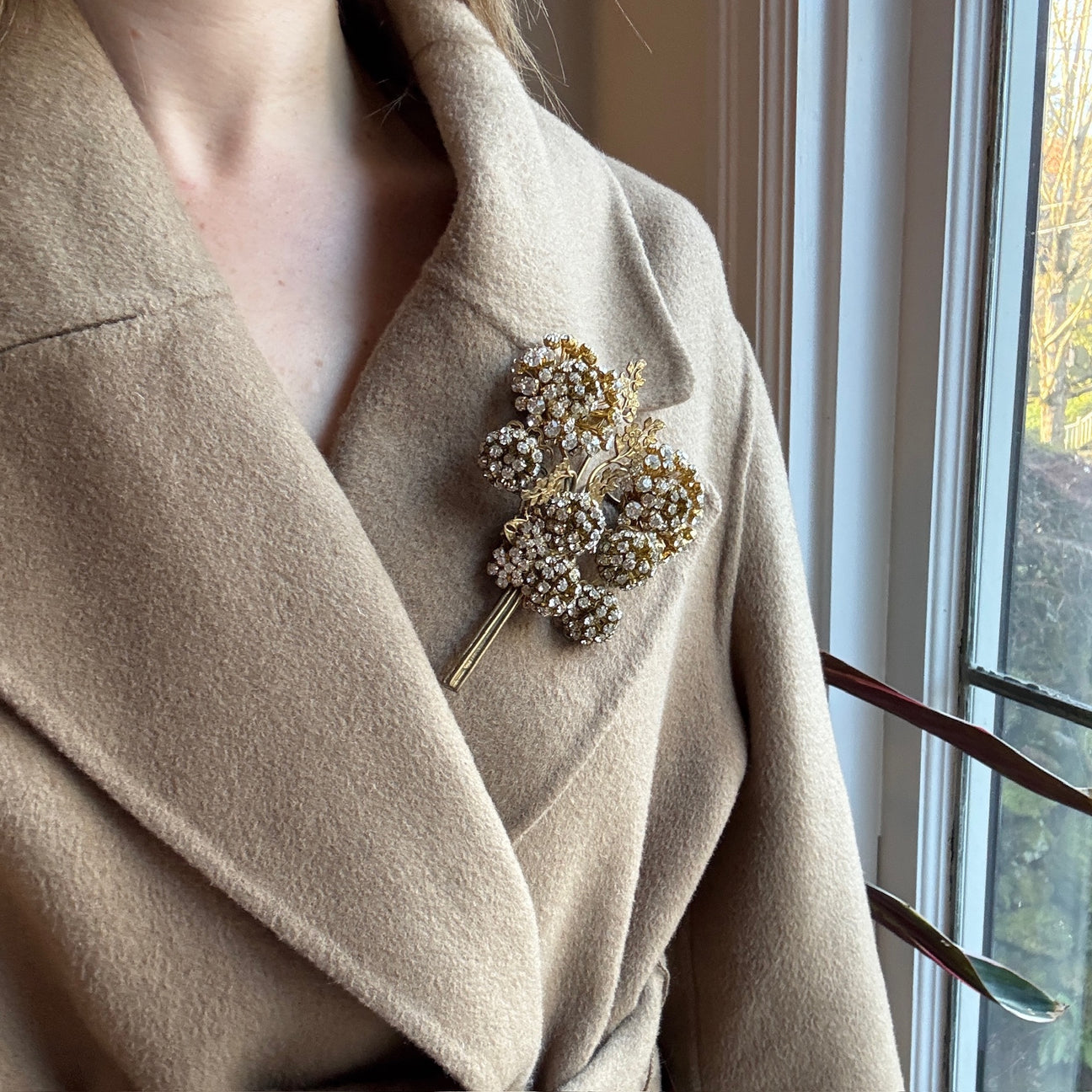 Hands securing a brooch with a locking pin back