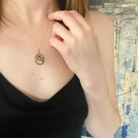 Serious Young Woman in Crystal & Gold Locket