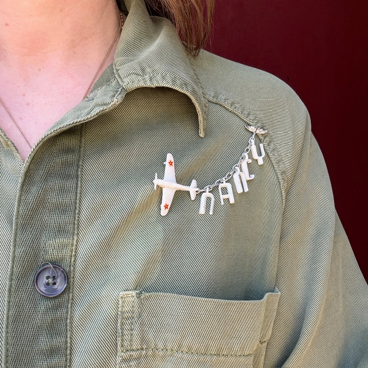 Nancy's Sweetheart WWII Celluloid Army Plane Brooch