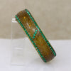 Carved Celluloid Bangle with Green & Orange Stones