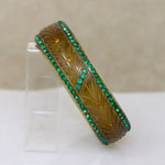 Carved Celluloid Bangle with Green & Orange Stones