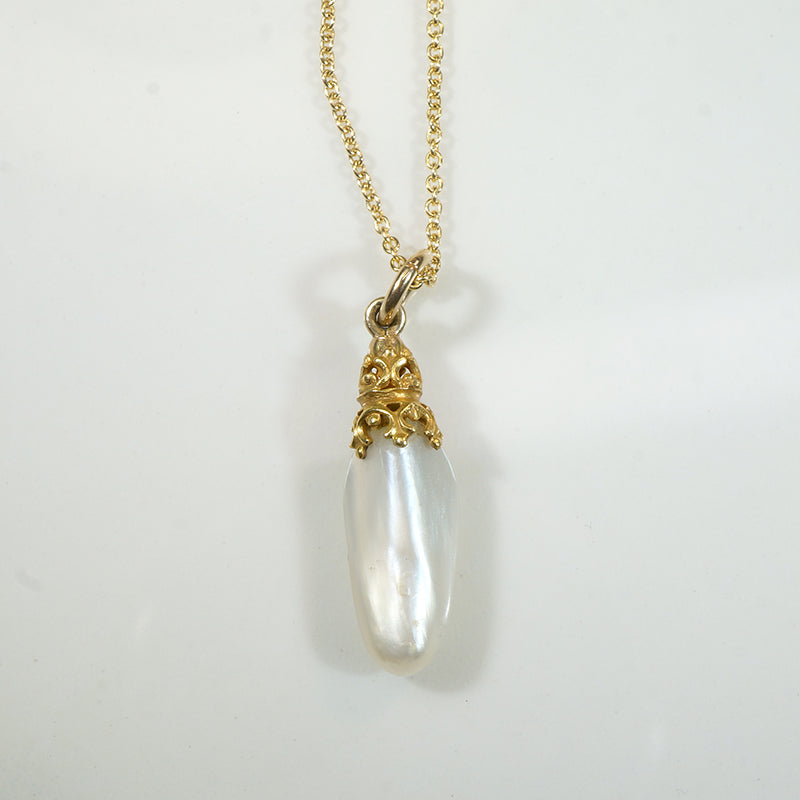 Glossy Baroque Pearl Pendant Crowned in Gold