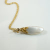 Glossy Baroque Pearl Pendant Crowned in Gold