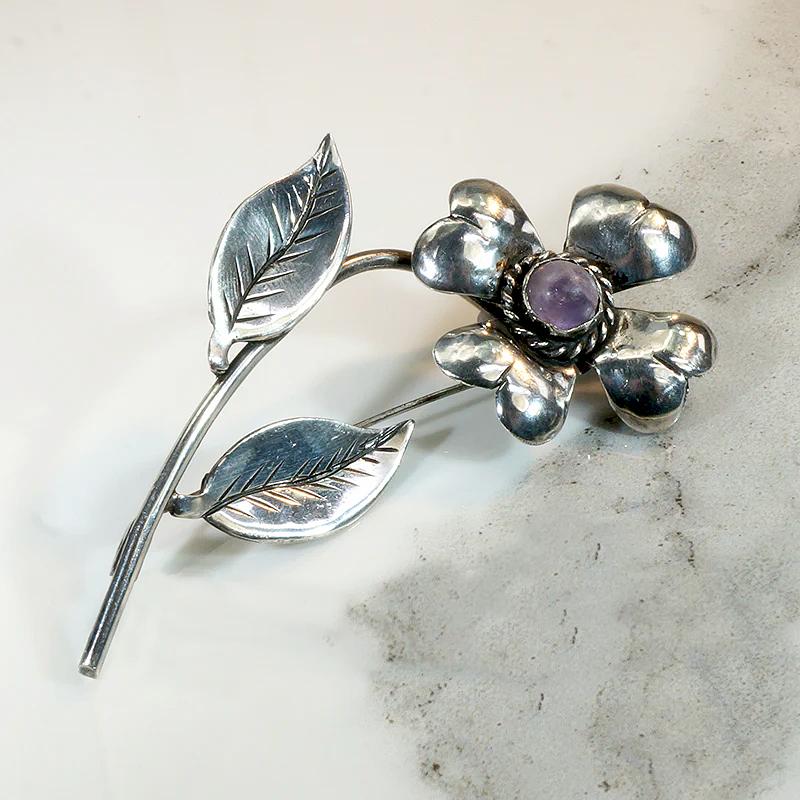 Playful Silver Flower Brooch with Amethyst Pistil
