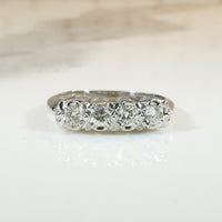 Four Sparkling Diamonds in Curvy White Gold Band