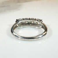 Four Sparkling Diamonds in Curvy White Gold Band