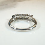 Four Sparkling Diamonds in Curvy White Gold Band