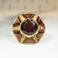 almandine garnet ring set in a star shape in 18k yellow gold