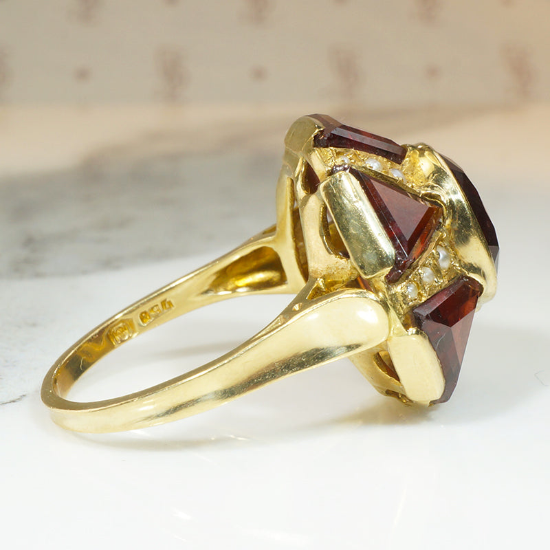 almandine garnet ring set in a star shape in 18k yellow gold