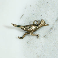 I'm a 9k Gold Roadrunner Charm Honey