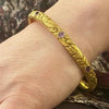 American Art Nouveau 14k Repoussé Bangle Bracelet set with Amethysts. On the wrist.