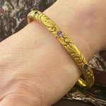 American Art Nouveau 14k Repoussé Bangle Bracelet set with Amethysts. On the wrist.