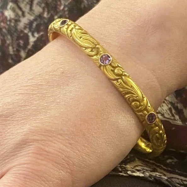 American Art Nouveau 14k Repoussé Bangle Bracelet set with Amethysts. On the wrist.