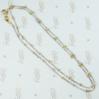18k white gold cuban link chain with a shiny finish and 18k yellow gold bead staions