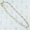 18k white gold cuban link chain with a shiny finish and 18k yellow gold bead staions