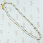 18k white gold cuban link chain with a shiny finish and 18k yellow gold bead staions