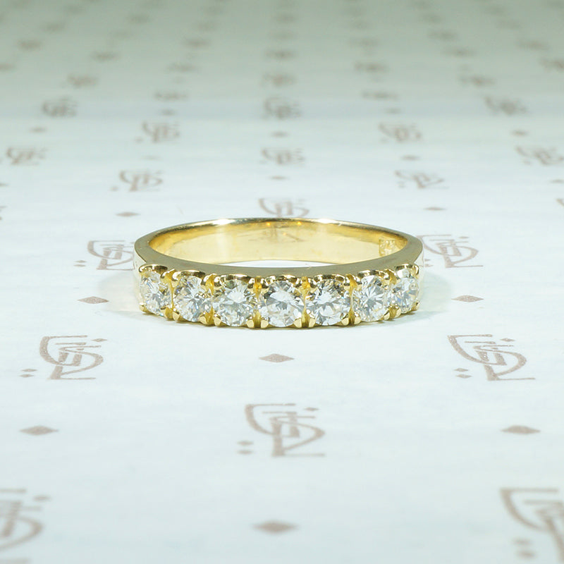 rich 18k yellow gold band set with 3/4 ct of round diamonds