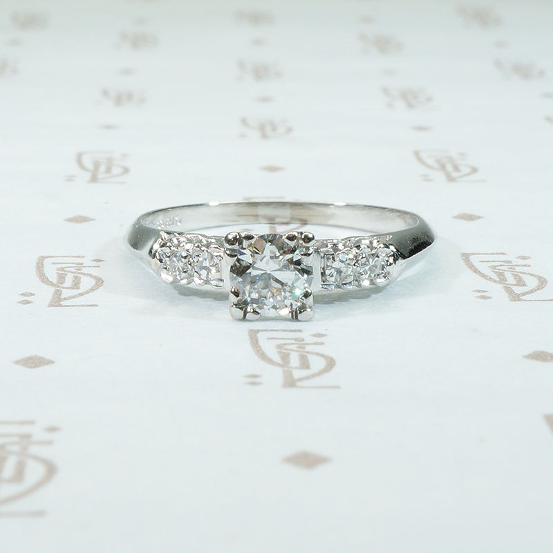 pretty 1940's knife edge platinum diamond engagement ring with side diamonds