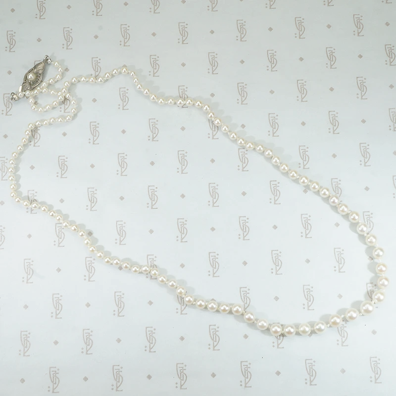21" long strand of pearls with sterling silver clasp hand knotted