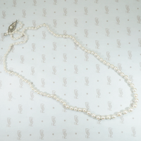 21" long strand of pearls with sterling silver clasp hand knotted