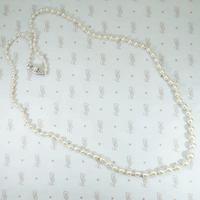 14k white gold filigree clasp 24" long strand of graduated pearls