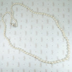14k white gold filigree clasp 24" long strand of graduated pearls