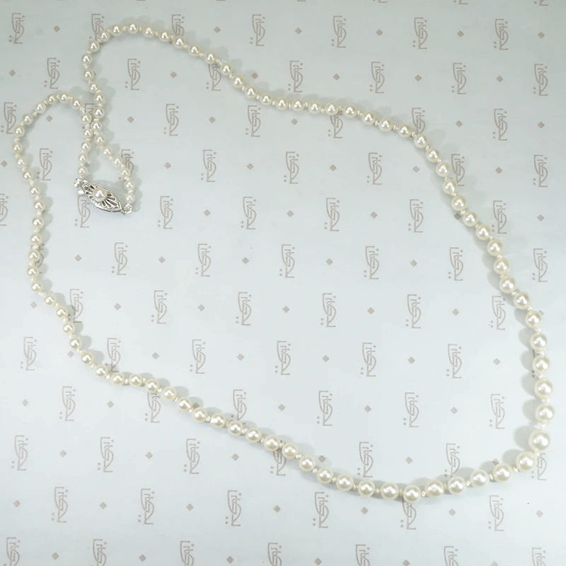 14k white gold filigree clasp 24" long strand of graduated pearls