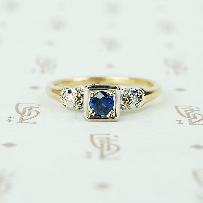 2 tone white and yellow gold 1940's engagement ring with sapphire and side diamonds
