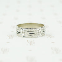 wide white gold band with forget me nots