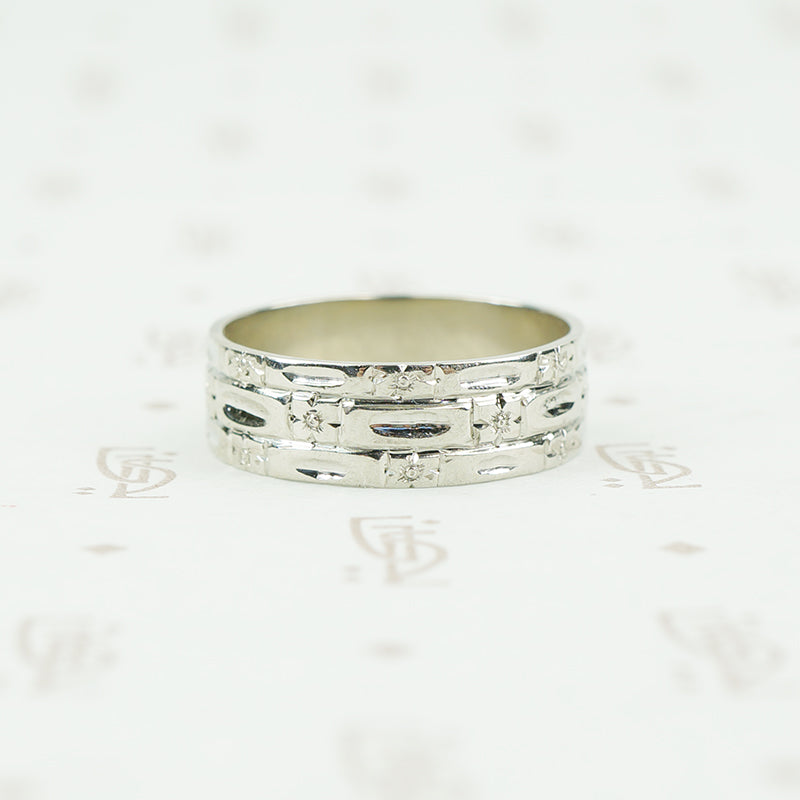 wide white gold band with forget me nots