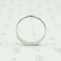 wide white gold band with forget me nots side view