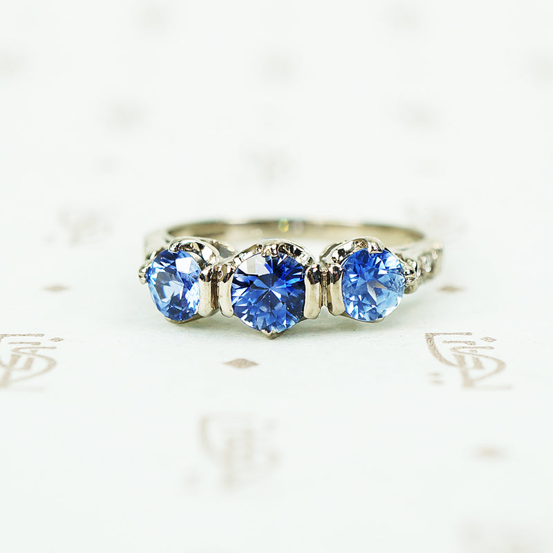 3 denim blue sapphires in 18k white gold with diamond side accents