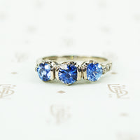 3 denim blue sapphires in 18k white gold with diamond side accents