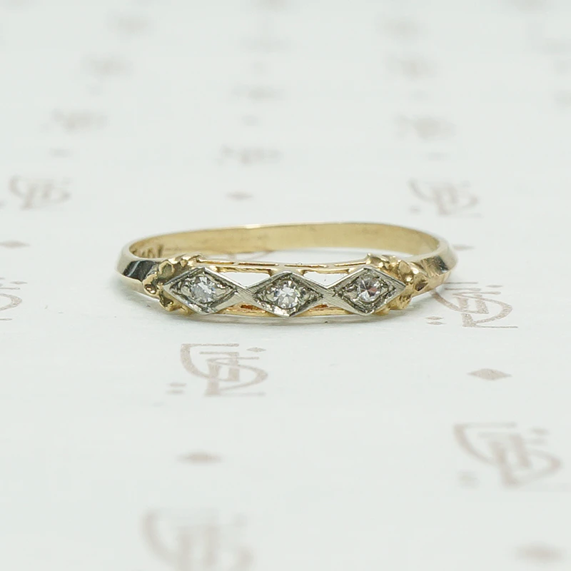 2 tone 14k gold ring set with 3 small round diamonds in diamond shapes across the front