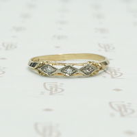 2 tone 14k gold ring set with 3 small round diamonds in diamond shapes across the front