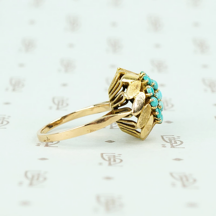 1960's 14k yellow gold and turquoise flower ring side view showing alternating brushed and shiny gold petals