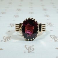 3 carat oval wine red garnet claw set in a 14k yellow gold victorian cigar band solitaire ring