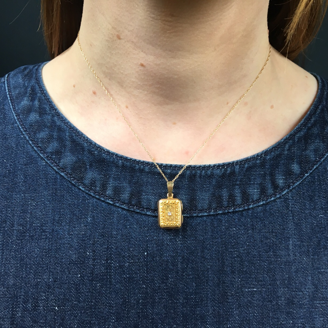 Delicate Gold Filigree Locket with Diamond Accent