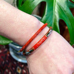Pair of Cinnabar Bangles, One with Cloisonné Flowers