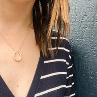 Fortuitous Pearl-Set Gold Horseshoe Pendant