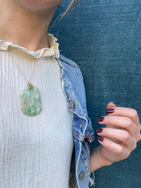 Hand Carved Antique Jade suspended from 22k Gold and Emerald