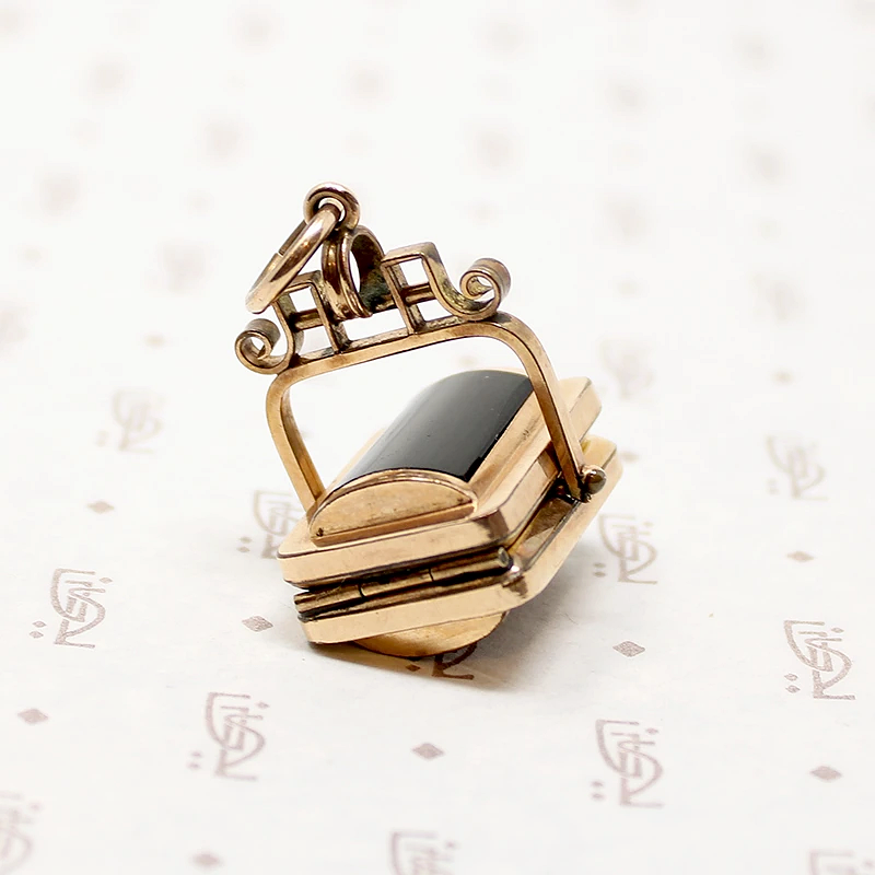 It spins in an ornate gold filled frame, perfect for fidgeting with. 