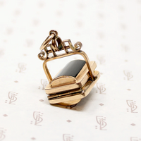 It spins in an ornate gold filled frame, perfect for fidgeting with. 