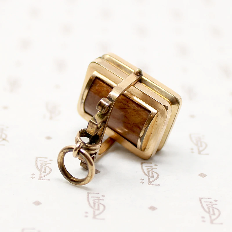 It spins in an ornate gold filled frame, perfect for fidgeting with. 