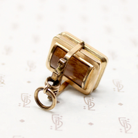It spins in an ornate gold filled frame, perfect for fidgeting with. 