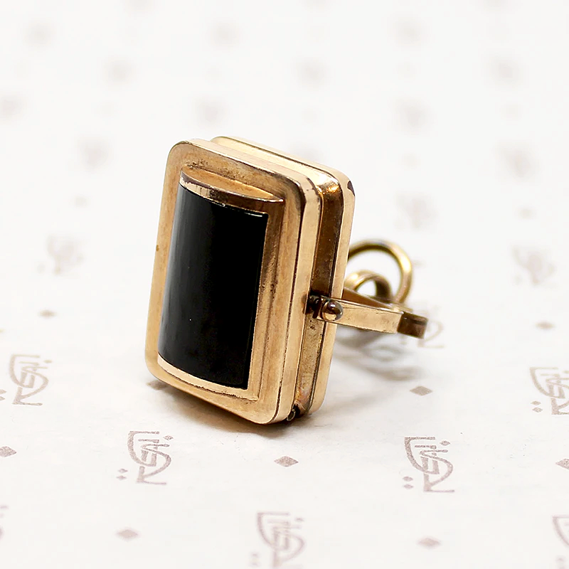 It spins in an ornate gold filled frame, perfect for fidgeting with. 